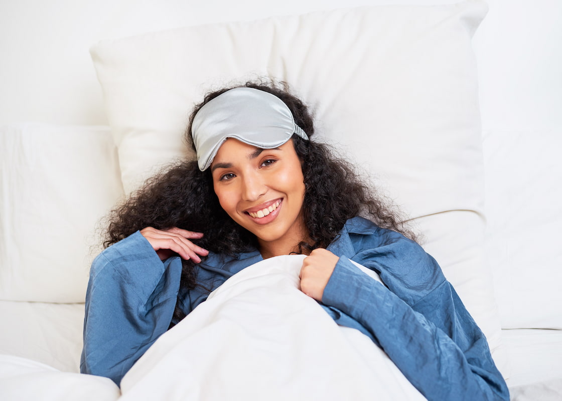 Woman with curly hair laying in bed Woman with curly hair laying in bed